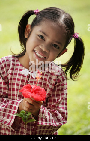 Front view of litlle girl holding flower Stock Photo