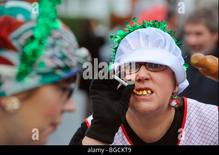 Villagers compete in their annual Boxing Day pram race event. East Hoathly near Lewes, UK. A competitor with joke teeth. Stock Photo