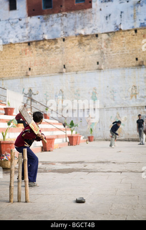 Cricket is the national sport of India, and is played even on the banks of holy Ganges River. Stock Photo