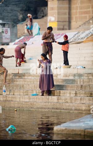 Woman praying for Mother Ganga, the holy Ganges River, in Varanasi, India. Stock Photo