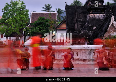 Laos; Luang Prabang; A long exposure image of Monks collecting alms at dawn Stock Photo