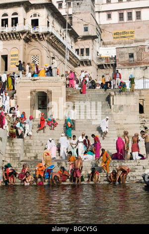 Crowds gather to the banks of holy Ganges River for ritual morning bath. Varanasi, India. Stock Photo