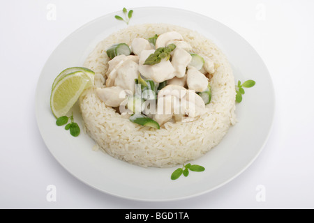 Chicken fricassee with mushrooms and green asparagus surrounded by a rice border Stock Photo