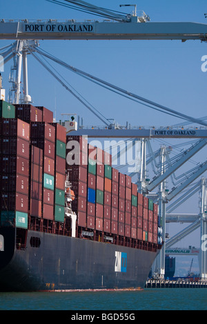 Cargo Container Ship Loaded with Portainers at Port of Oakland Docks Stock Photo