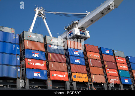 Stacks of portainers loaded onto a cargo container ship Stock Photo