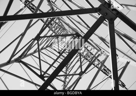 View from below looking up in an electricity pylon, black and white Stock Photo