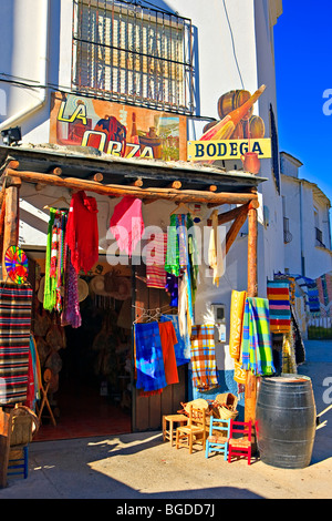 Hand woven blankets and clothing outside La Orza Bodega and gift store in the town of Trevelez, Las Alpujarras, Sierra Nevada, P Stock Photo