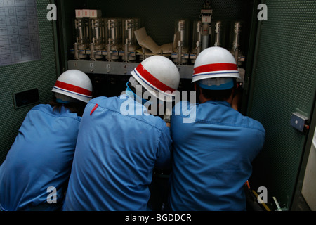 Three electricians working on an electrical box, Tokyo, Japan, Asia Stock Photo