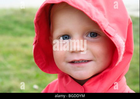 Portrait of a little girl with a red rain jacket Stock Photo