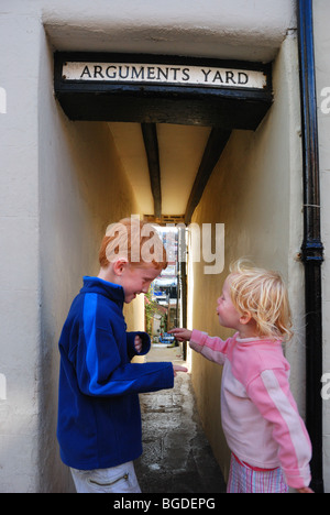 Children having an argument in Arguments Yard, a street in Whitby, England