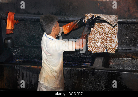 Dyeing in a batik factory, near Yogyakarta, Central Java, Indonesia, Southeast Asia Stock Photo