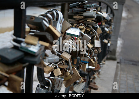 Locks as a sign of love on a bridge in Bastejkalns Park in Riga, Latvia, Baltic region, Northern Europe Stock Photo