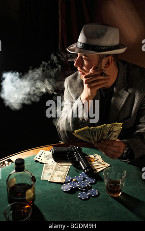 portrait of young gangster smoking and play poker Stock Photo