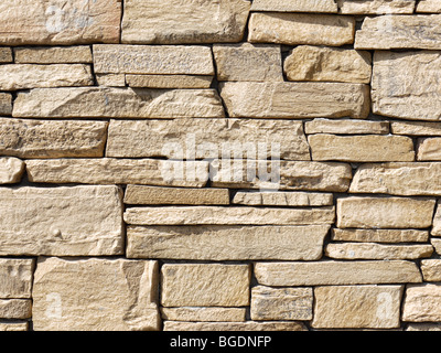 Closeup shot of house wall made from beige slate rocks Stock Photo