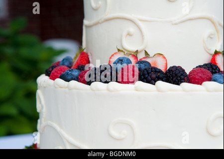 Multi-layered white wedding cake with fruit Stock Photo