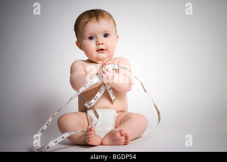 Baby girl with tape measure Stock Photo