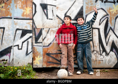 Two south American youths take a break from playing football (soccer) Stock Photo