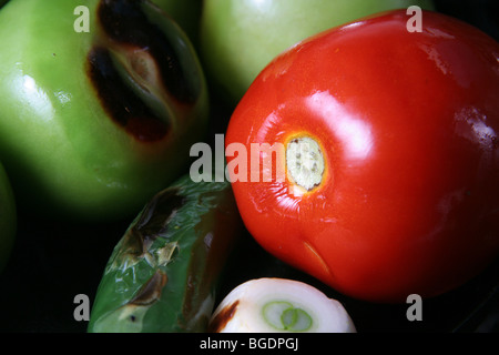 Mexican ingredients being prepared for sauce. Green tomato, red, pepper, onion. Stock Photo