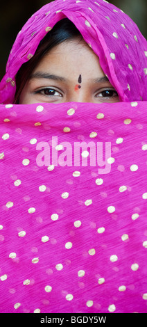 Smiling happy Indian girl wearing a pink shawl Stock Photo