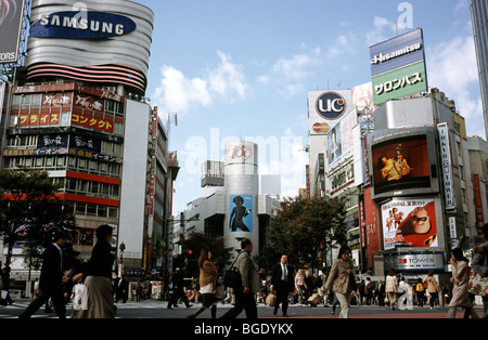 People cross what is reportedly the world's busiest scramble crossing in central Tokyo's Shibuya in Japan. Stock Photo