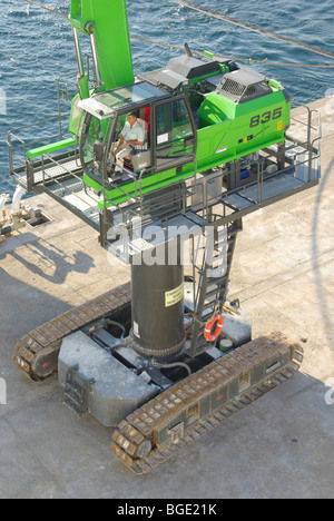 Dockyard mobile crane with caterpillar tracks and driver Stock Photo