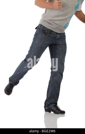 Single male tap dancer wearing jeans showing various steps in studio with white background and reflective floor. Not isolated Stock Photo