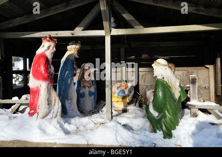 Christmas nativity scene outdoors with snow showing Jesus in manger with 3 Wise Men Stock Photo
