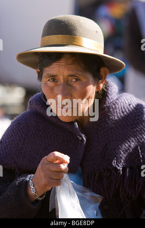 Old Bolivian woman in traditional dress and hat in marketplace in the town of Uyuni, S.W. Bolivia, S.America Stock Photo