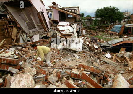 The 1999 earthquake in Colombia was the strongest to strike for 16 years. A man searches through the remains of his home. Stock Photo