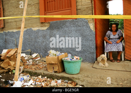 The 1999 earthquake in Colombia was the strongest to strike Colombia for 16 years. A survivor sits by her damaged home. Stock Photo