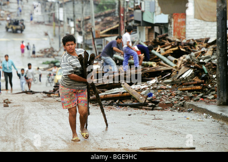 The 1999 earthquake in Colombia was the strongest to strike Colombia for 16 years. Salvaging some timber from the rubble. Stock Photo