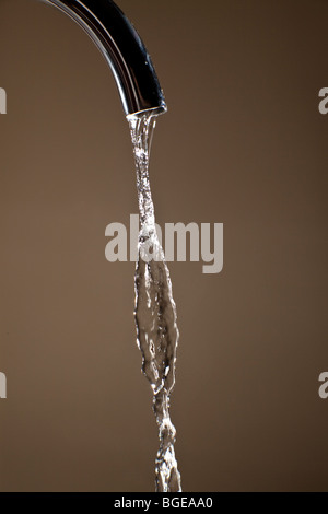 Water running from a domestic tap. Stock Photo