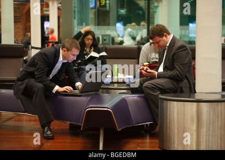 Business travellers wait for a Eurostar train at St Pancras Station, London, UK Stock Photo