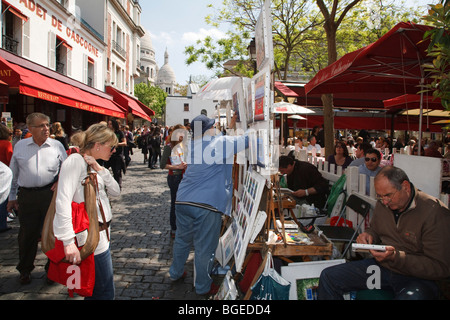 Tourists browse artist stalls at Place du Tertre in Montmartre, Paris, France Stock Photo