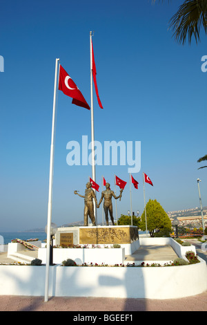 Monument of Ataturk and Youth, Kusadasi, Turkey with Turkish flags in the background. The monument signifies peace and hope Stock Photo