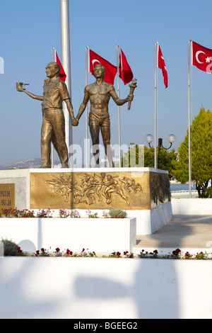 Monument of Ataturk and Youth, Kusadasi, Turkey with Turkish flags in the background. The monument signifies peace and hope Stock Photo