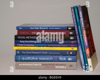 University textbooks on a light coloured plain background Stock Photo
