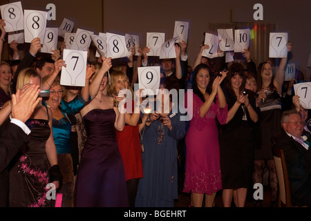 Friends and relatives of newlyweds score the couples' first dance in the evening reception after her wedding. Stock Photo