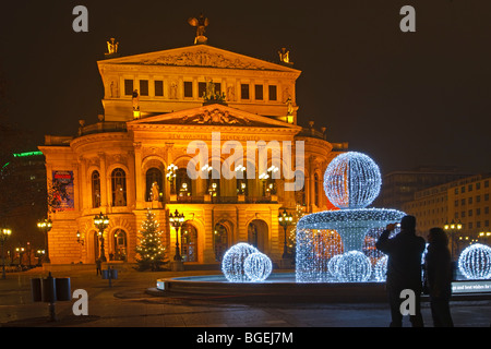 The Old Opera House, Alte Oper Frankfurt, and its fountain decorated with lights at dusk, downtown Frankfurt, Hessen, Germany, E Stock Photo