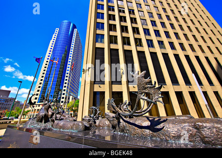 Bronze sculpture of caribous crossing a river, titled 'Seal River Crossing' outside the Richardson Building with the Canwest Pla