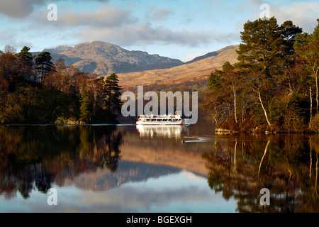 A tourist boat crosses Loch Katrine on a beautiful winters day