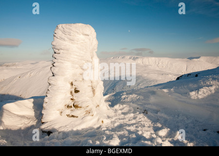 Hoare frost patterns on the trig point on the summit of Red Screes in the Lake District, UK Stock Photo