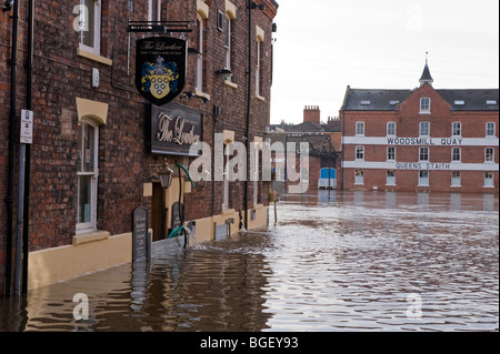River Ouse burst its banks after heavy rain (road submerged, high flood water, flooded building being pumped out) - York, North Yorkshire, England UK. Stock Photo