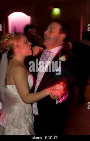 A bride's father dances with his daughter at the reception of her wedding at a licensed ceremony in Essex, England. Stock Photo