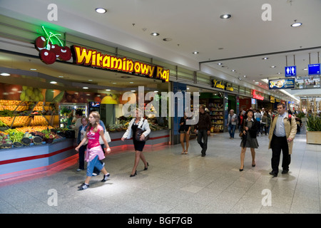 View inside Galeria Krakowska shopping mall in Krakow town centre. Poland. A fruit and vegetable store is on the left. Stock Photo