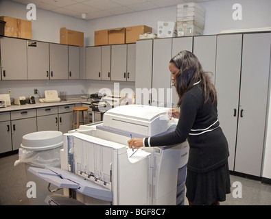 Detroit, Michigan - A Detroit Public Schools secretary uses a photocopier at Cass Technical High School. Stock Photo