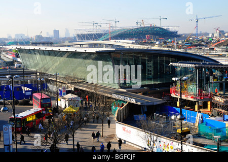 Stratford Train and Bus Station, London, with the 2012 Olympic Stadium and Aquatic Centre in the background Stock Photo