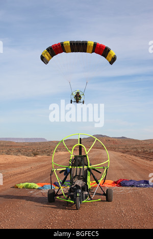 Power parachute flying over aircraft on ground in desert area of southern Utah. Near Saint George on dirt road. Recreation. Stock Photo