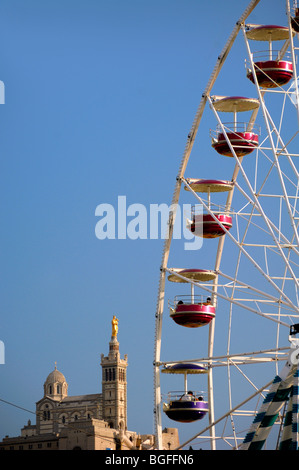 Giant Ferris Wheel Amusement Ride & Passenger Pods with View Notre-Dame de la Garde Church, Marseille or Marseilles Bouches-du-Rhone Provence France Stock Photo
