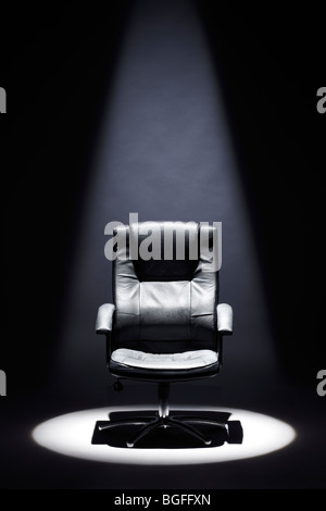 Empty Black Leather Chair under Spotlight Mastermind Stock Photo